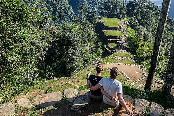 A couple looking at the view of the mountain top, stone terraced Lost City in Colombia.