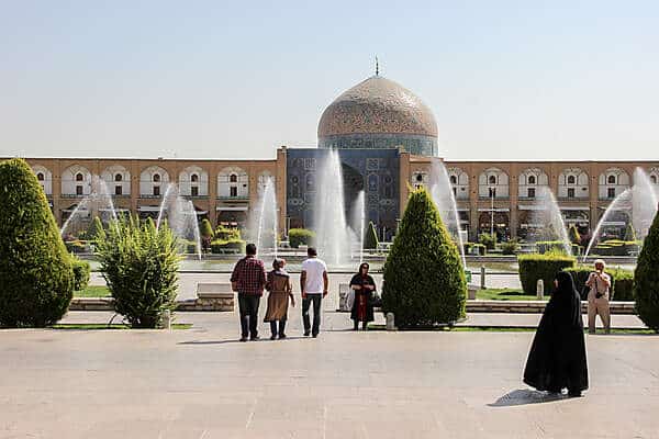 Visitors walking in the garden grounds in front of The Great Mosque Masjid-e Jameh of Isfahan on an Iran trip. 