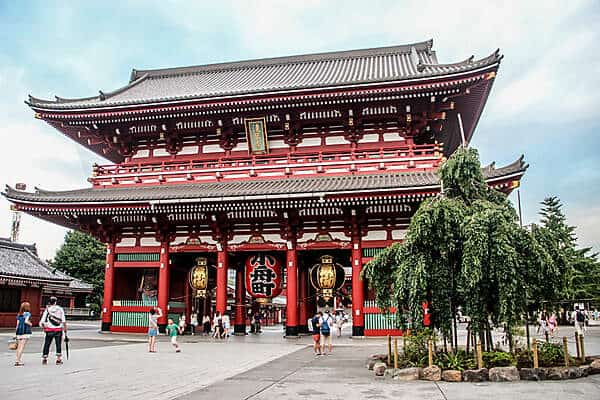 Visitors at the two-tiered red columned Sensoji Temple in Tokyo. 