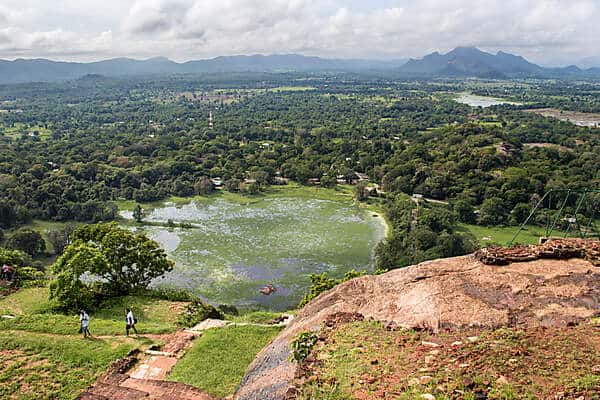 Hilltop view over ochre earth and vast green marsh land in Sri Lanka. 