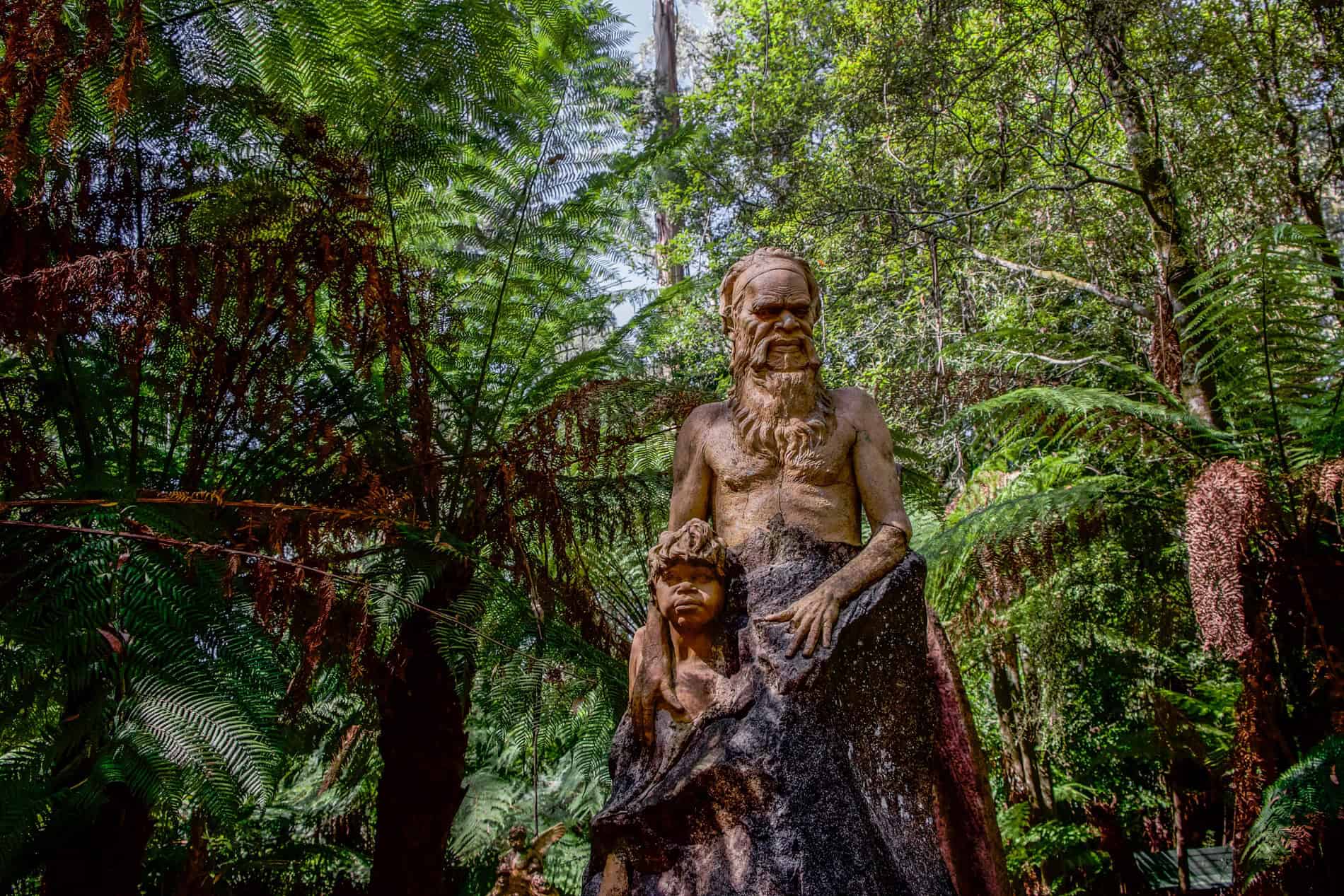 Wood carved sculptures of an Aboringinal man and boy in the William Ricketts Sanctuary in Australia. 