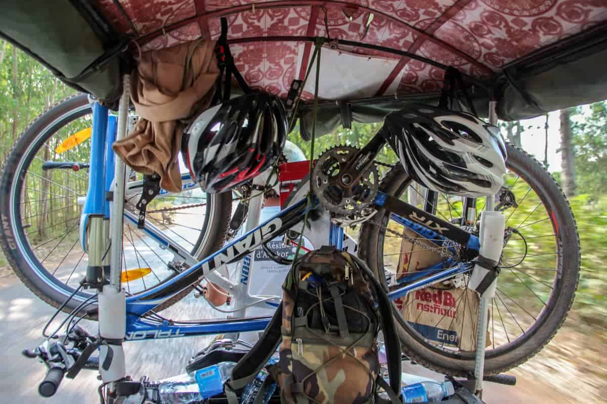 Two bikes attached to the back of a tuk tuk in Cambodia for easy transportation