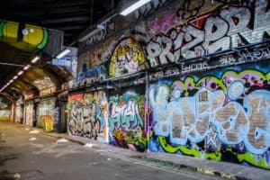 Spray paint artwork on the brick walls of the London Graffiti Tunnel.