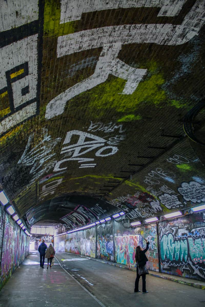 A woman takes a picture inside the Waterloo graffiti tunnel in London. 
