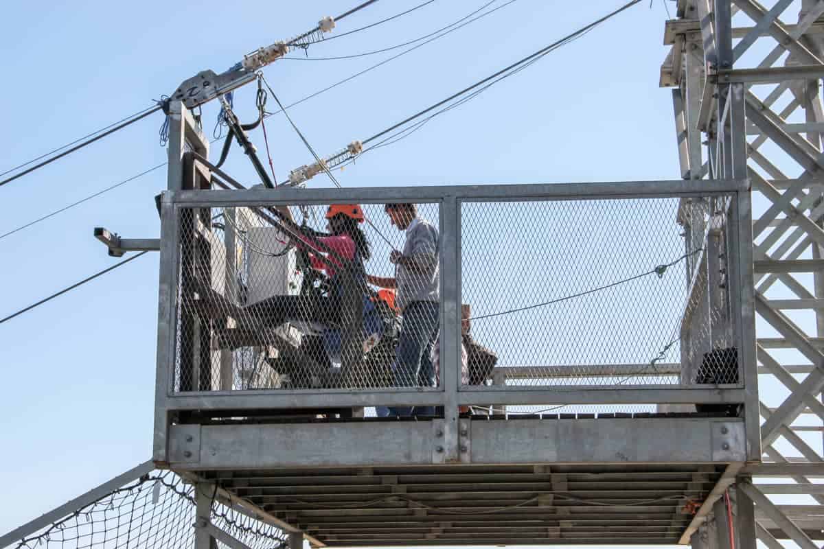 Tourists strapped in and waiting on the top of the zipline platform in Nepal 