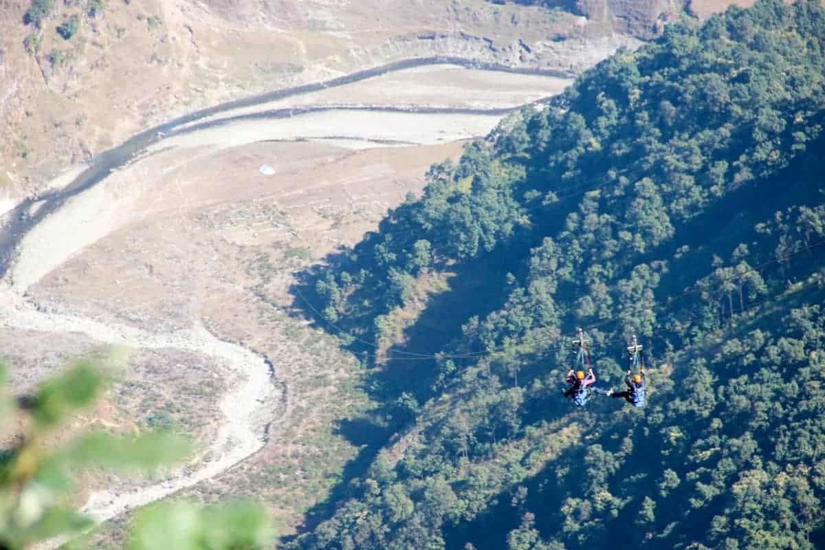 View of the ground and dried up riverbed from the heights of the Nepal zipline