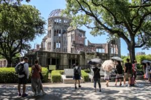 Tourists visiting the A-Bomb Dome in Hiroshima Peace Park Memorial - a hollow shell of a building charred by the Atomic bomb dropped on the city.