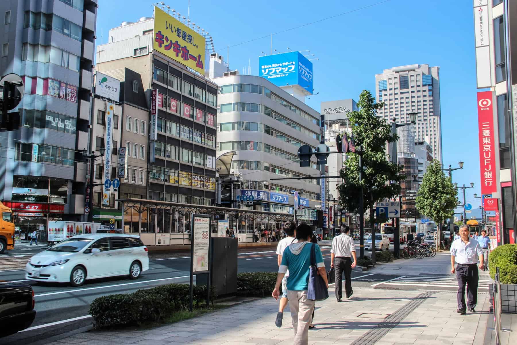 Pedestrians walking through the modern city of Hiroshima, Japan. 