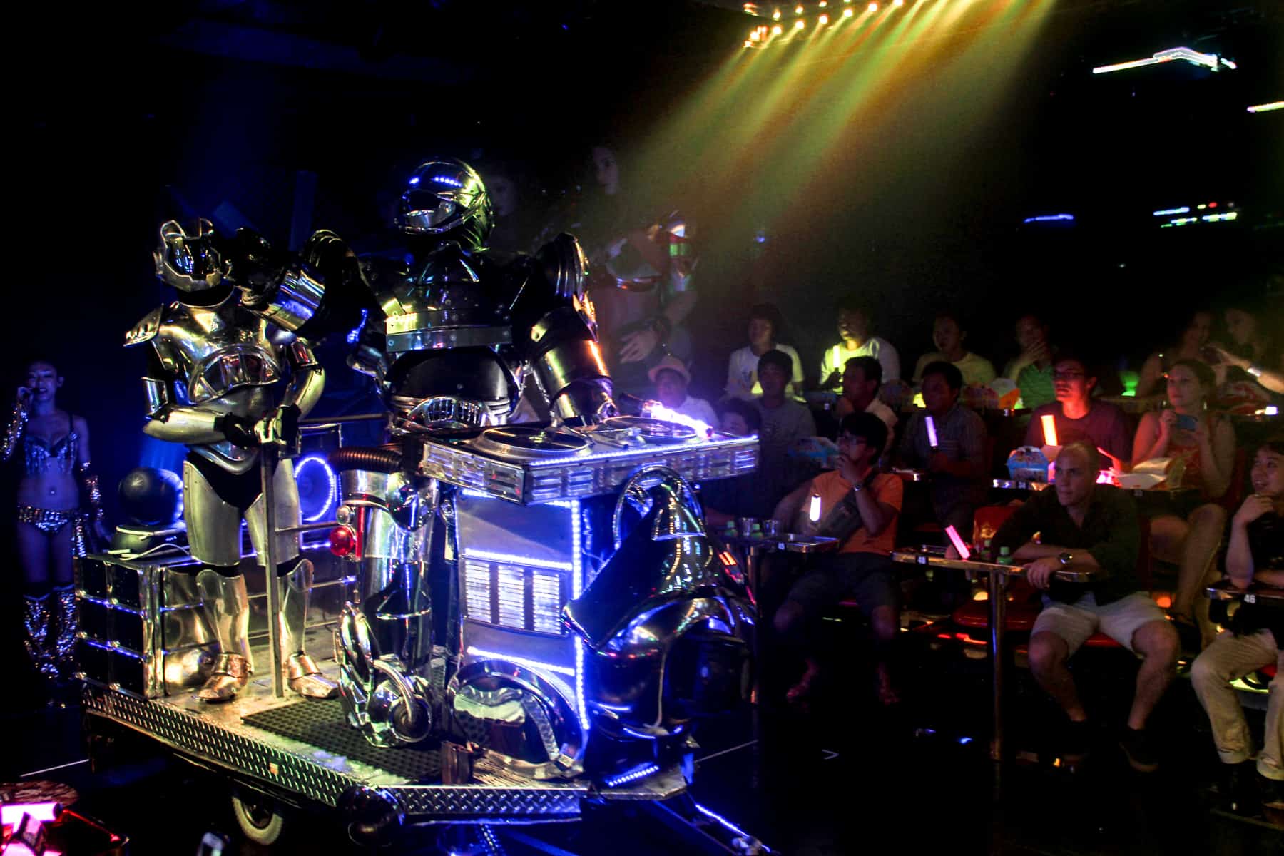 Two robots ride on a cart past the audience at the Shinjuko robot show in Tokyo. 