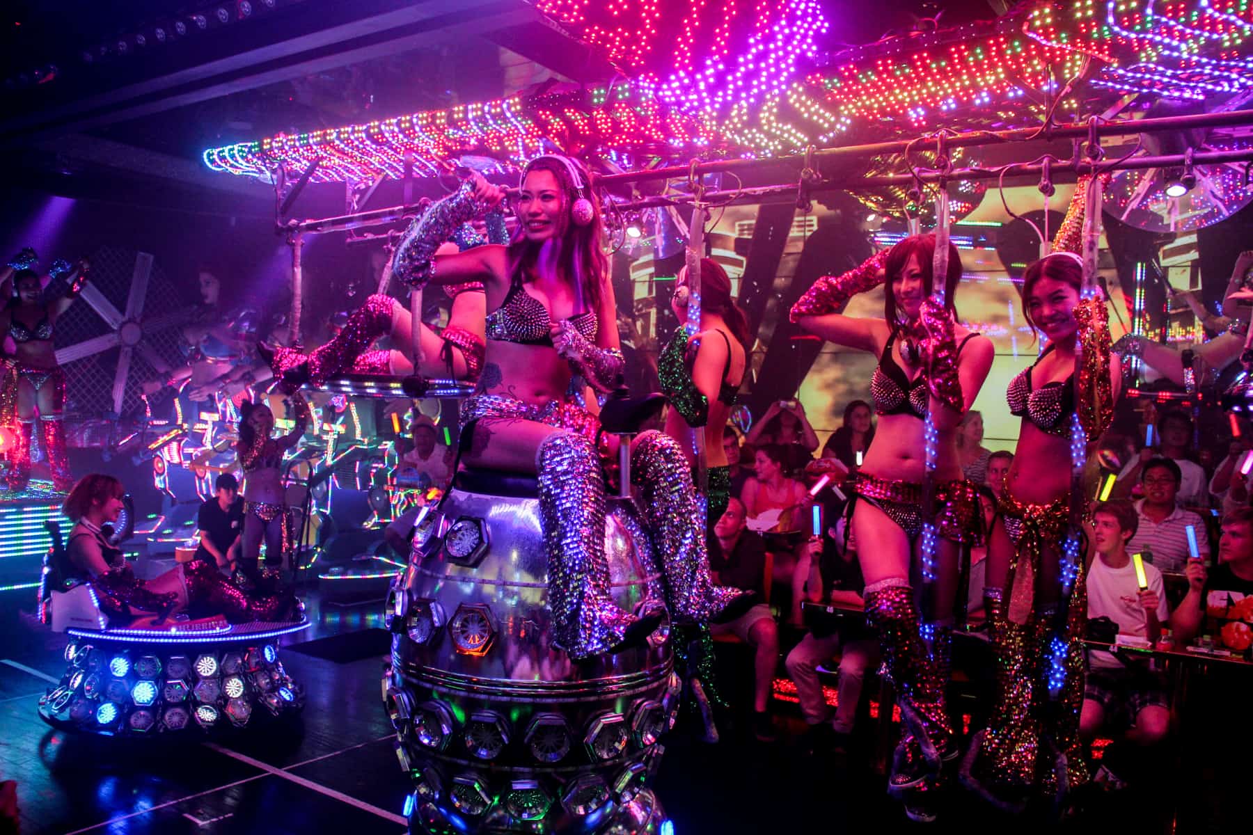 Women with dazzling outfits and robot props perform at the Robot Restaurant show in Tokyo. 