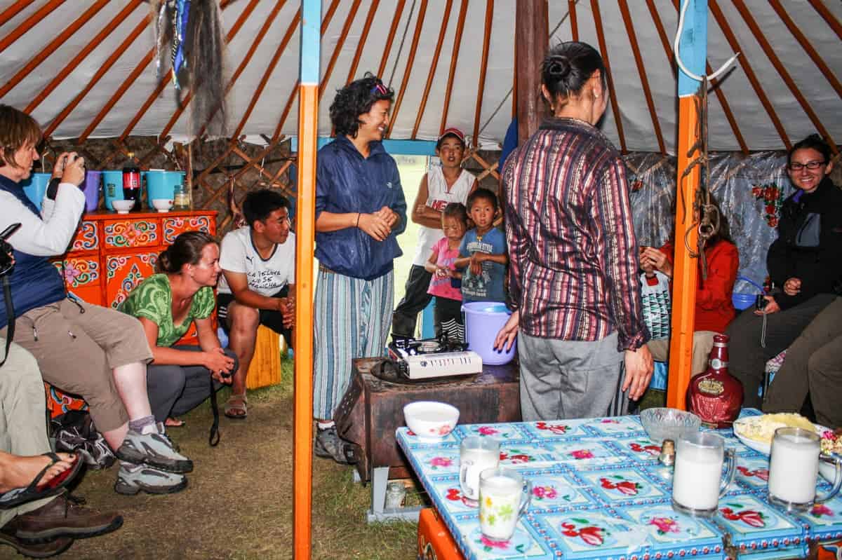 A small group of tourists visit a local nomadic family in their ger in Mongolia