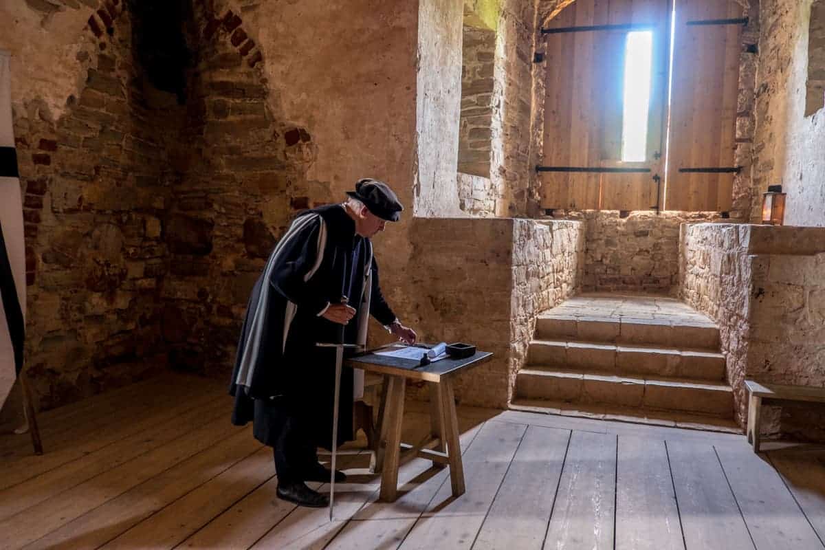 Actor plays his part of Master in the chambers of the Western Tower in Cesis Castle Latvia 