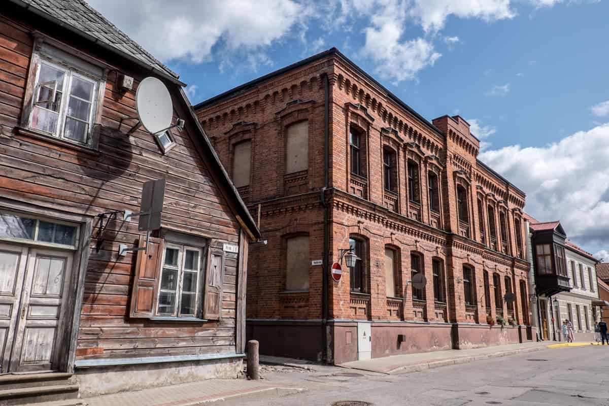 The brown and beige, old wooden buildings found in the streets of Cesis, Latvia