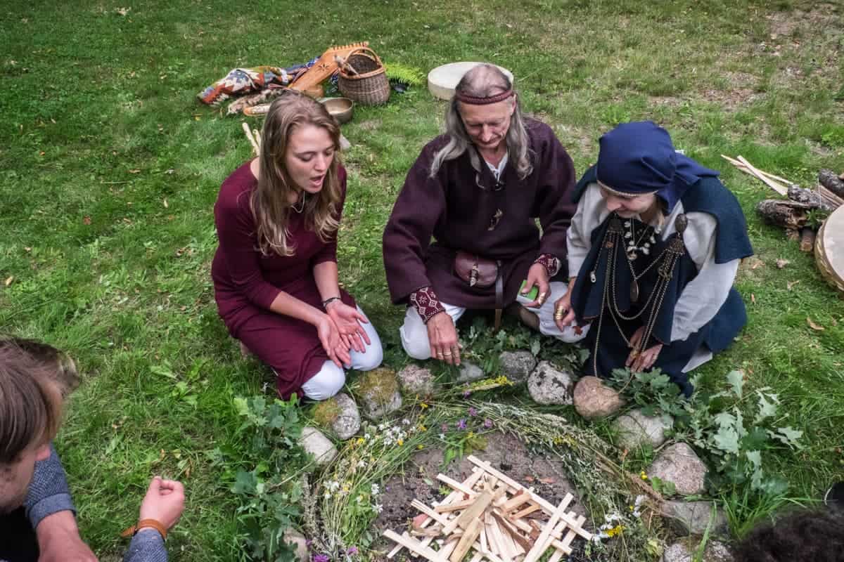 The flowers and wood set up in a circle for the Latvian fire ritual experience