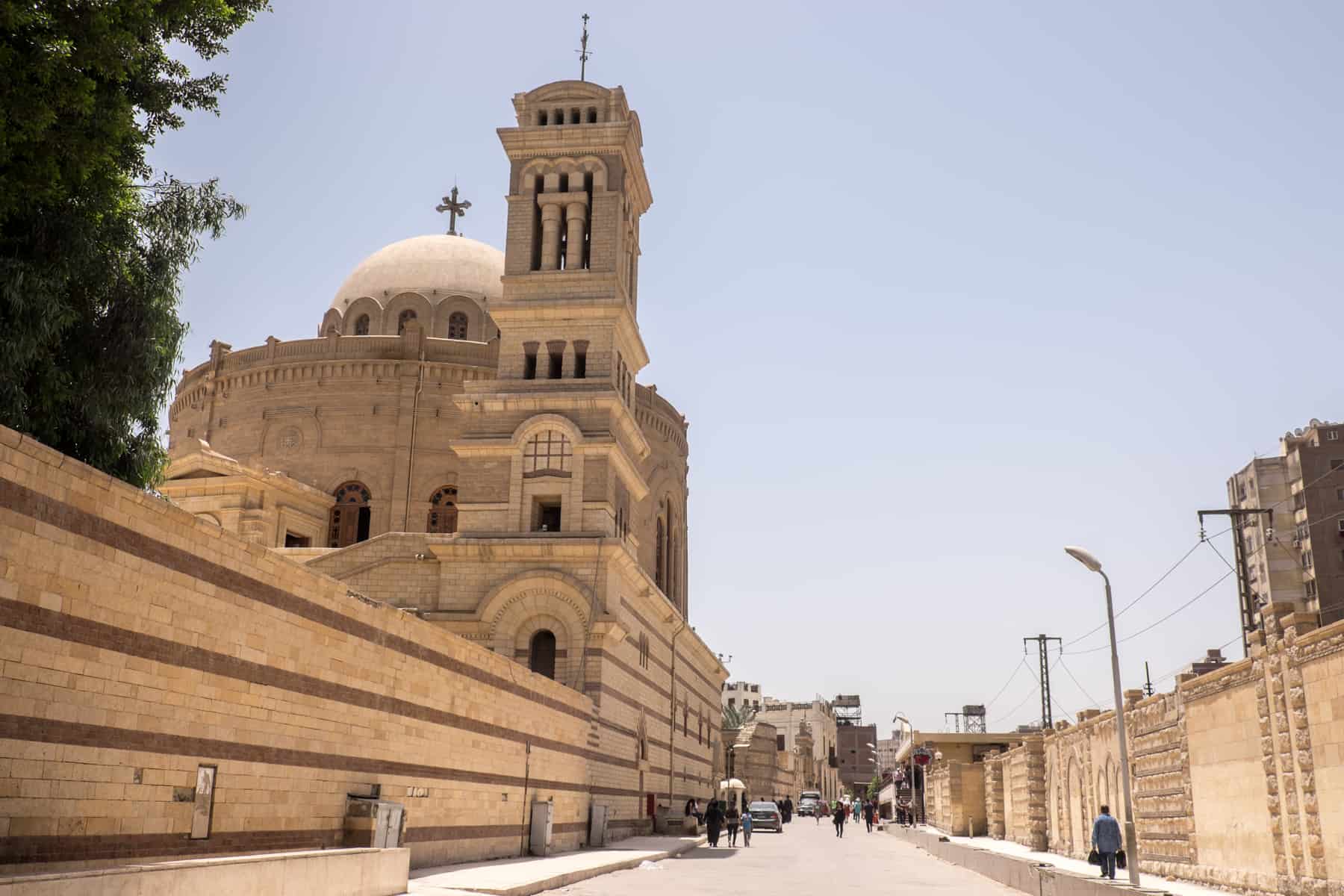 Street views of Egypt's Capital, Cairo and the pastel cream buildings of the old town with a church on the left hand side