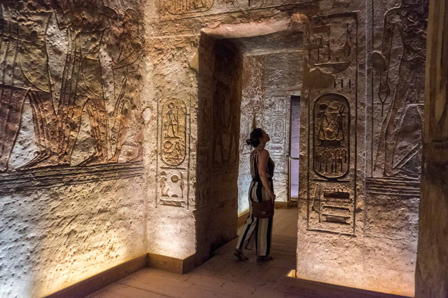 Inside the temple of Abu Simbel where wall carvings, pictures and Hieroglyphic are on show under golden light