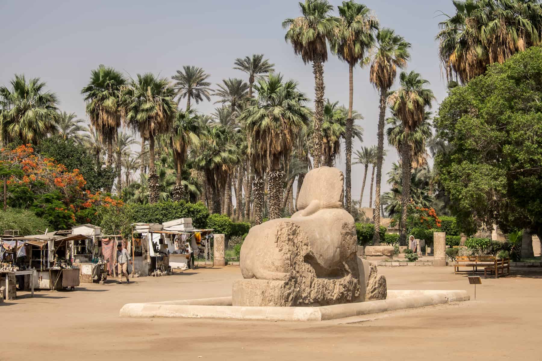 A small sphinx sits in the middle of the desert ground that makes up the museum of Memphis in Egypt - one of a few artefacts of Ancient Egypt on show outside