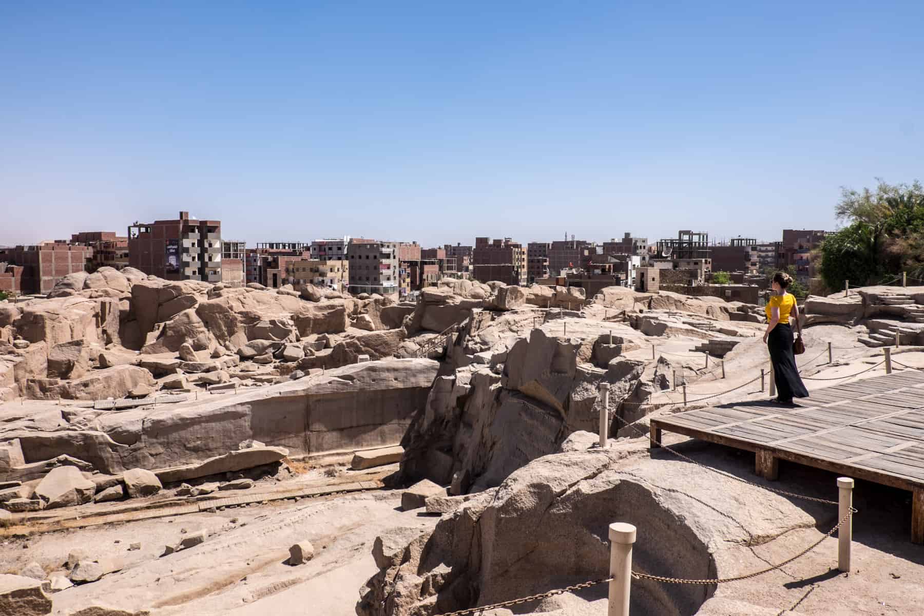 A woman stands overlooking the ancient quarry site in Aswan which contains the broken Unfinished Obelisk