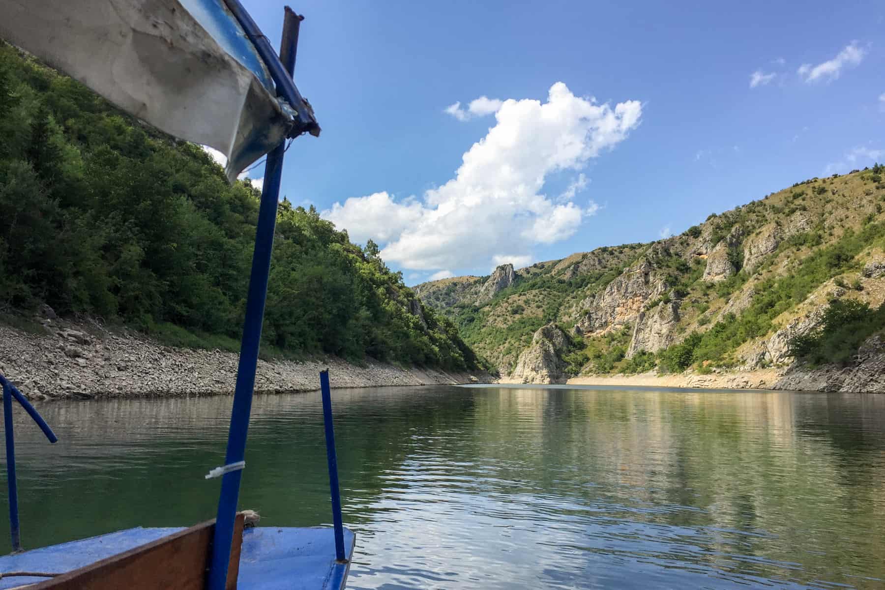 The wide expanse of the tree covered, high cliff, Uvac Gorge in Serbia seen from a boat. 