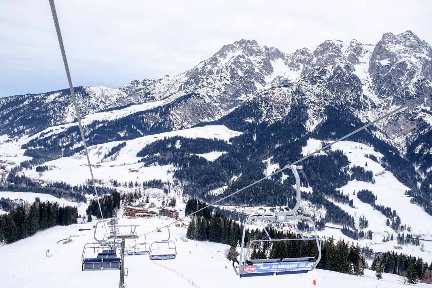 View from of the ski slopes from the cable cars gliding through the air, with the Salzburg mountains in the background