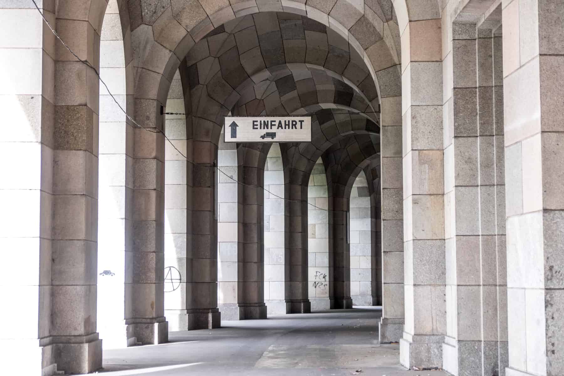 A repurposed structure, a sign within marble archways directs transport to the storage area at the Congress Hall former Nazi Party Rally Grounds site