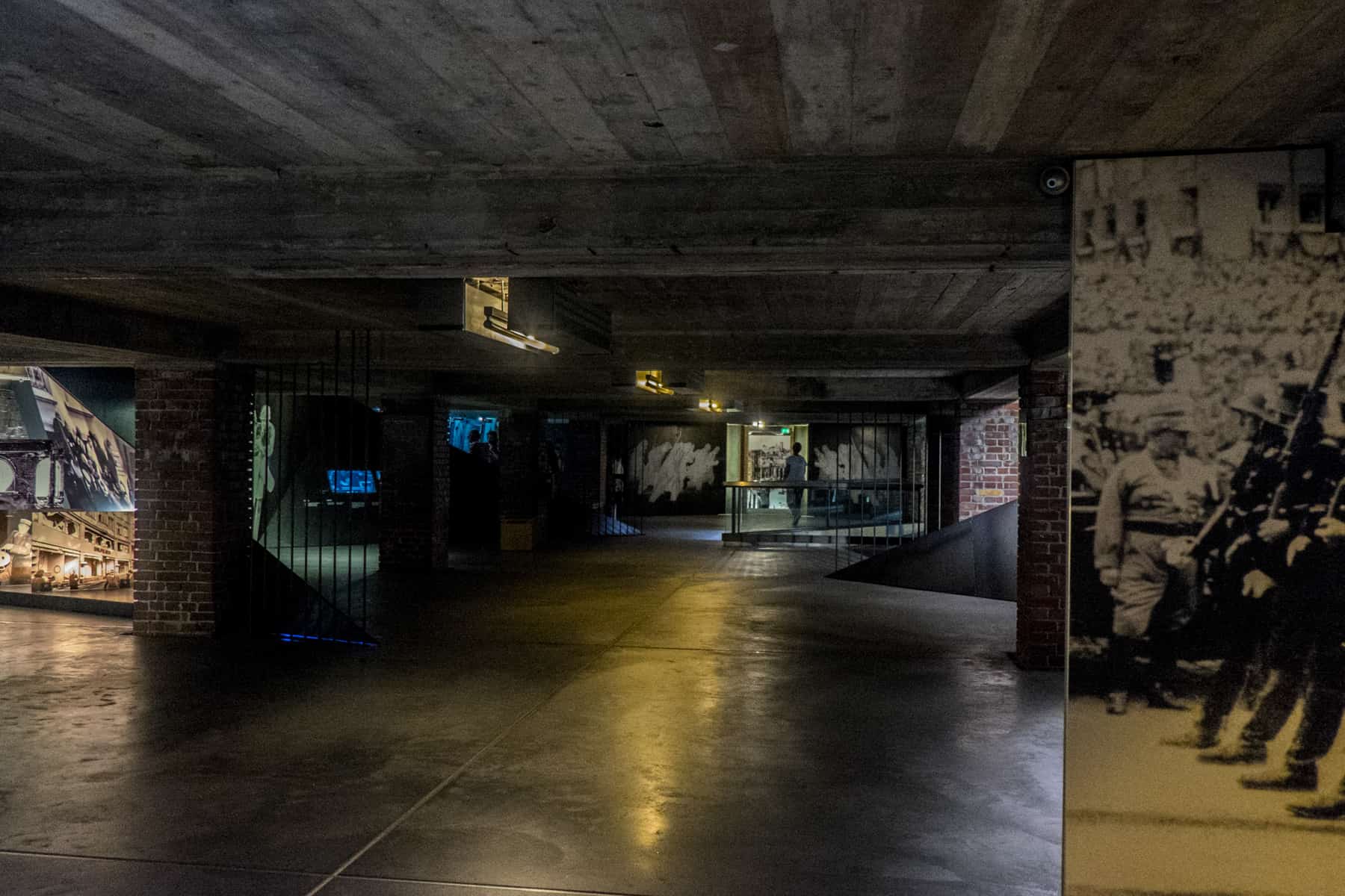 The displays in dark rooms for sombre atmosphere within the Nuremberg Documentation Centre exhibition