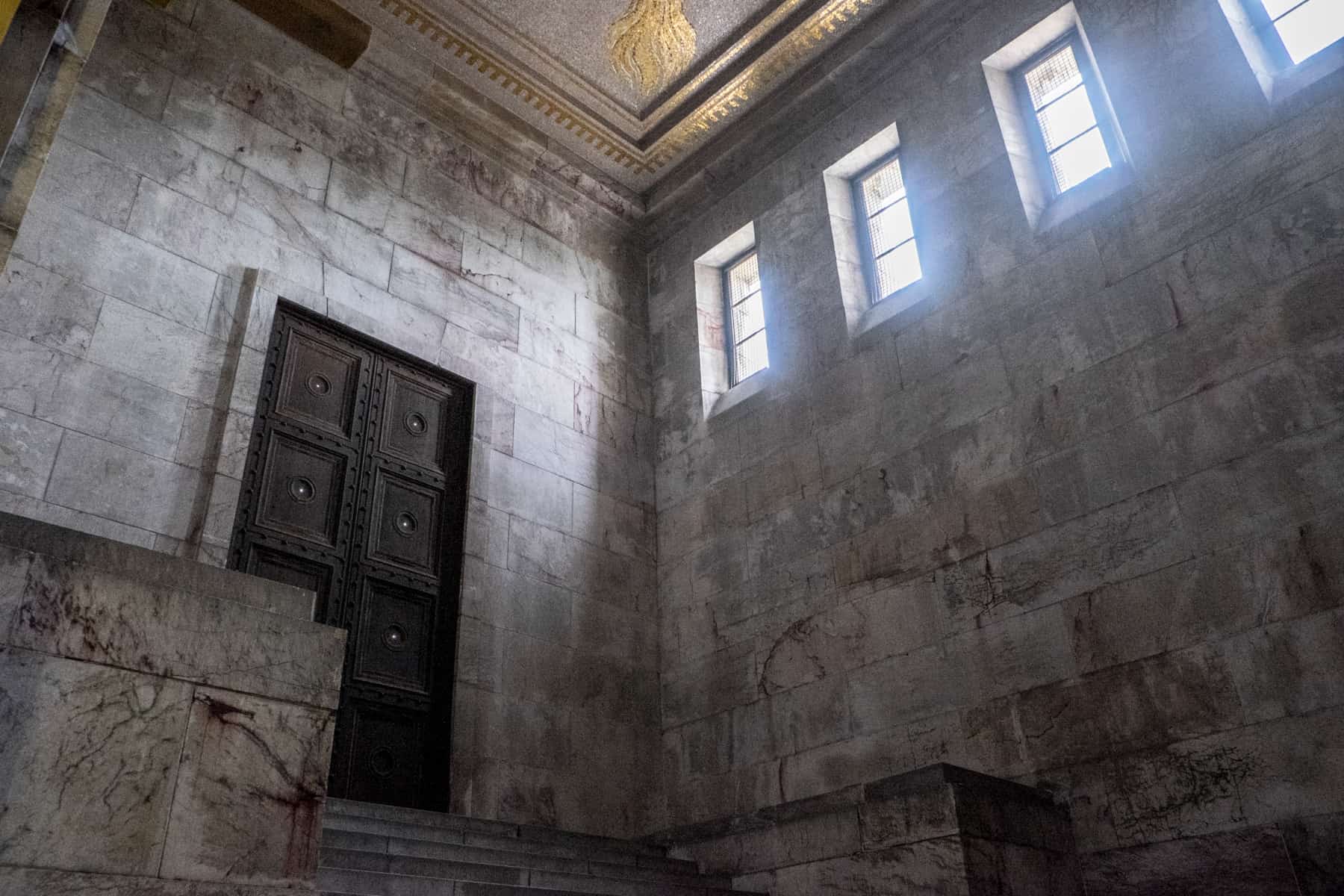 The tall dark looming doors and frightening looking red-tingled marble block walls Inside the Zeppelin Field Nazi Rally Ground site in Nuremberg