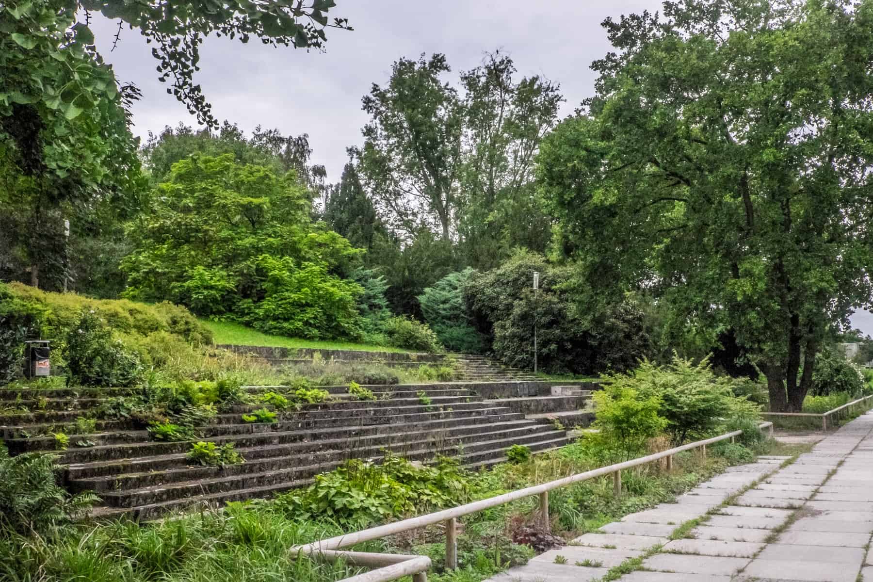 Grass, trees and green nature reclaims the structures of the Nuremberg Nazi Rally Grounds in Luitpoldhain