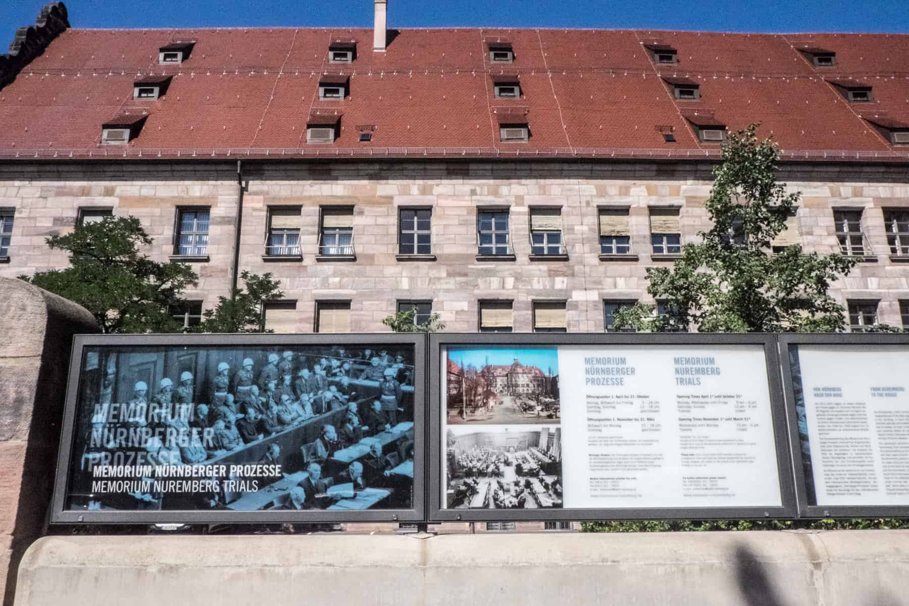 The red-roofed exterior and information boards outside the Palace of Justice where the historic Nuremberg Trails took place