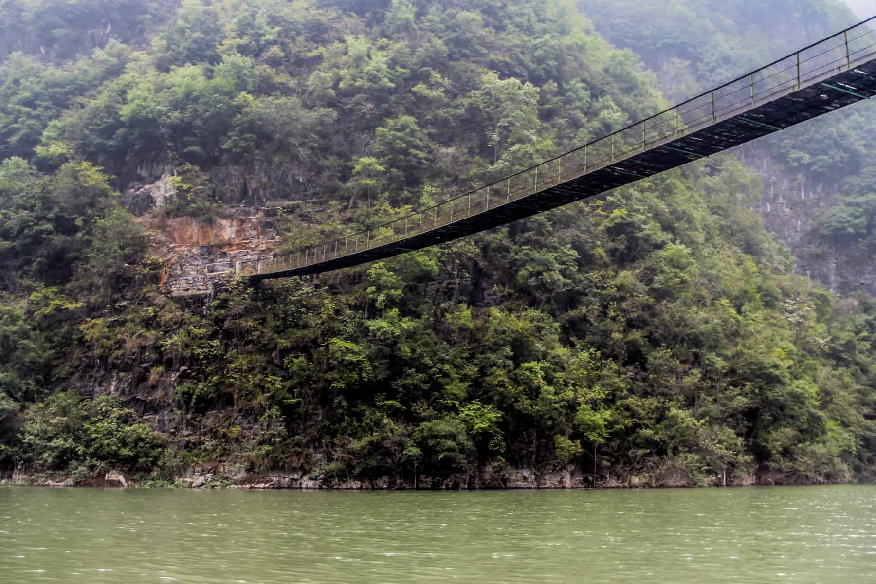 A long bridges connects two sides of the lush, green Gorges on the Yangtze River in China