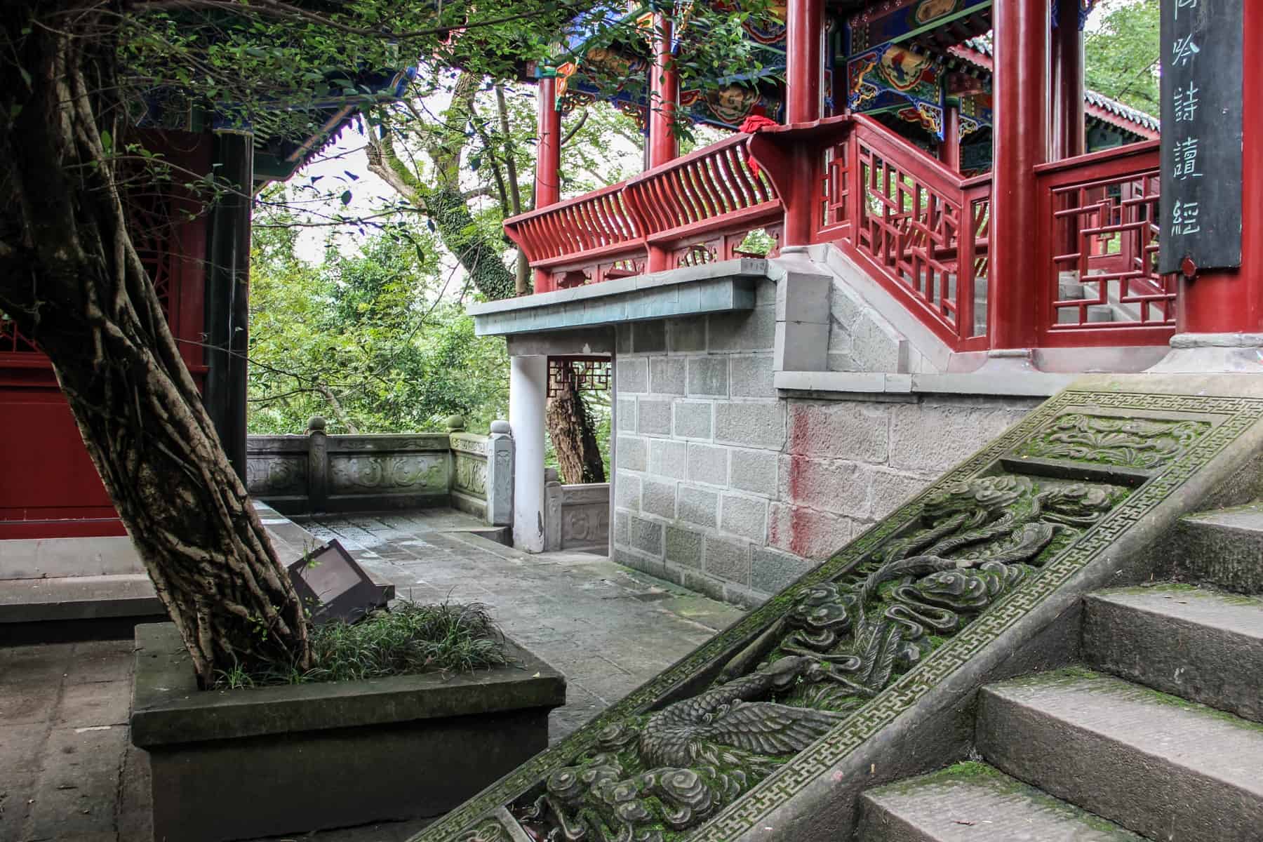 The etched stone staircase and red railings of a temple pagoda in Fengdu Ghost City in China