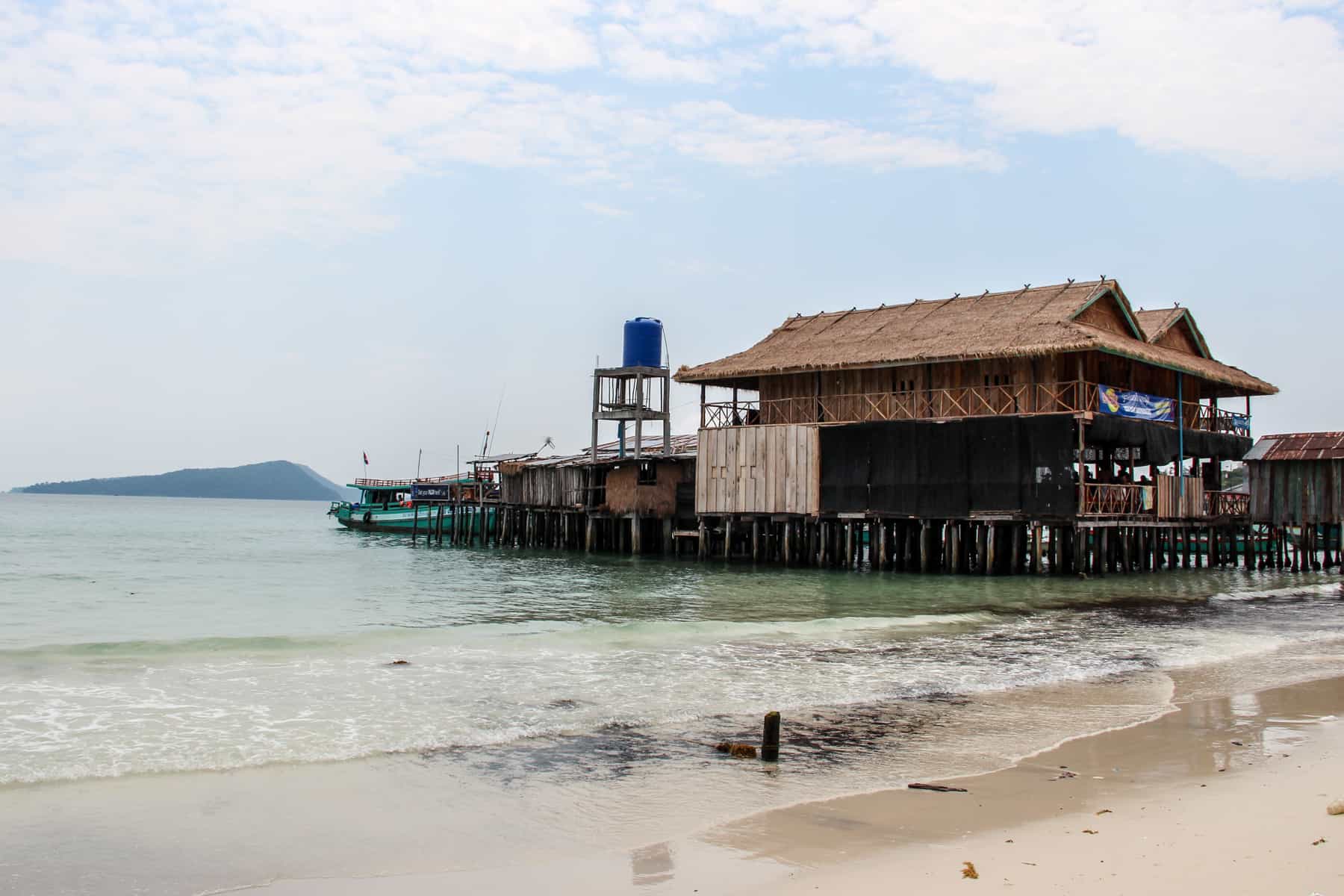 A stand building sits on a pier like structure on the coastline of Koh Rong. It's home to one of the Cambodian island's main hostels