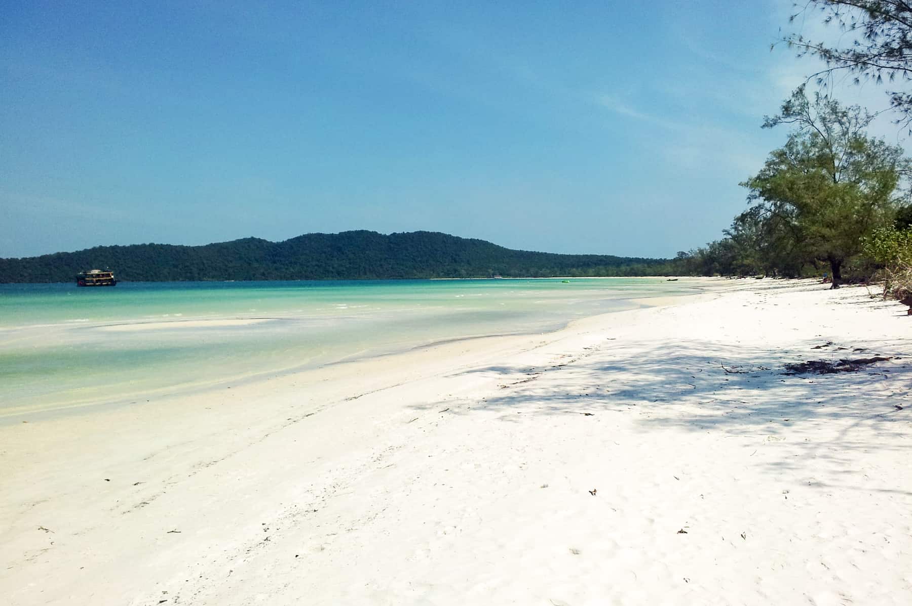 The untouched white sand beach of Koh Rong Samloem Cambodia that merges into agua water and a clear blue sky