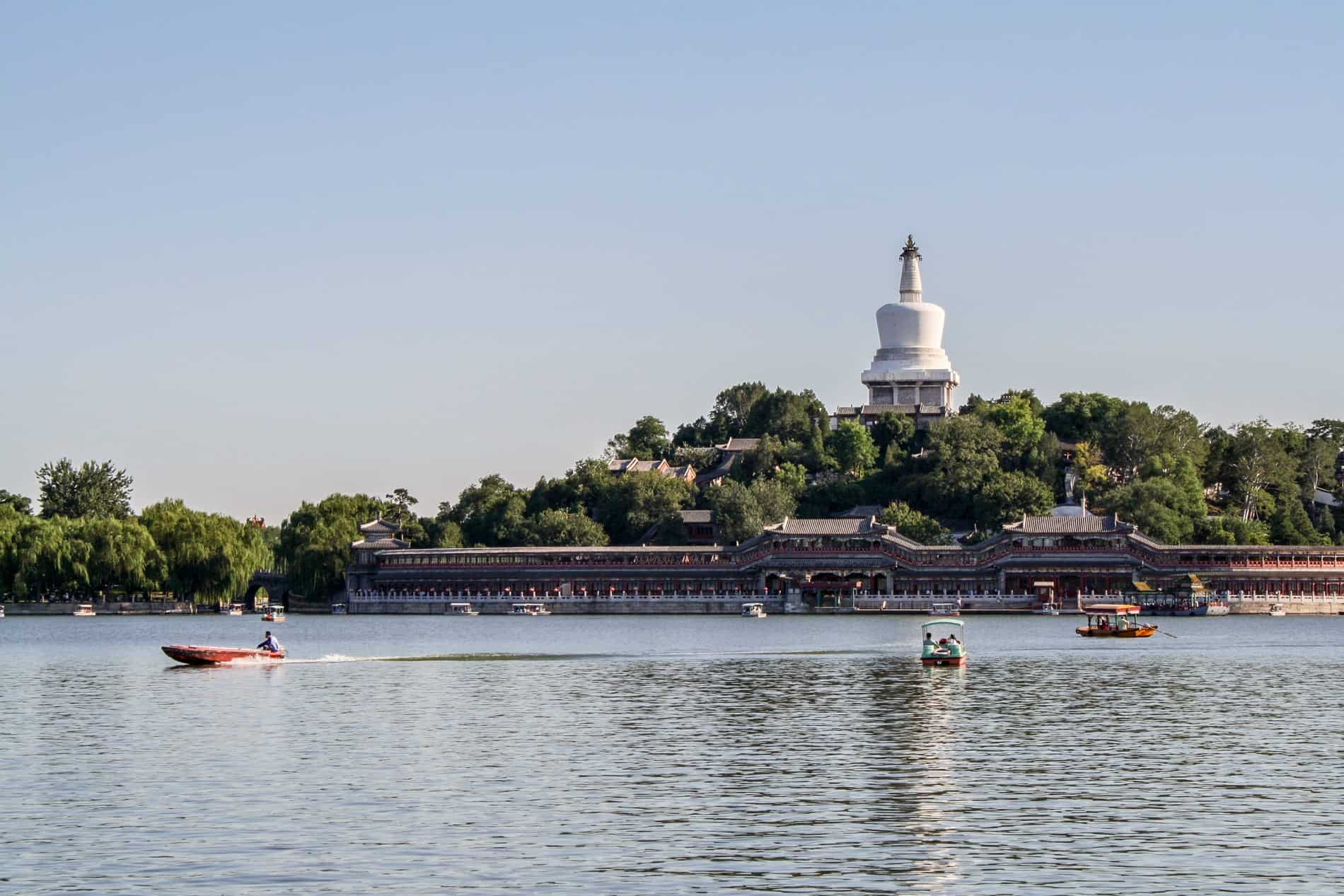 White pagoda on Beihai Park island on a boating lake. 