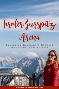 A woman in a red coat stands on top of Germany's Highest Mountain - the Zugspitze - that is also accessible from Austria. Behind are the peaks of the neighbouring mountain plateau