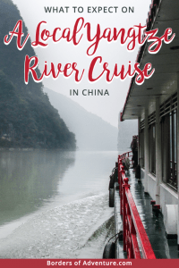 The exterior of a Yangtze River Cruise boat sailing on the misty green waters of the Yangtze River in China