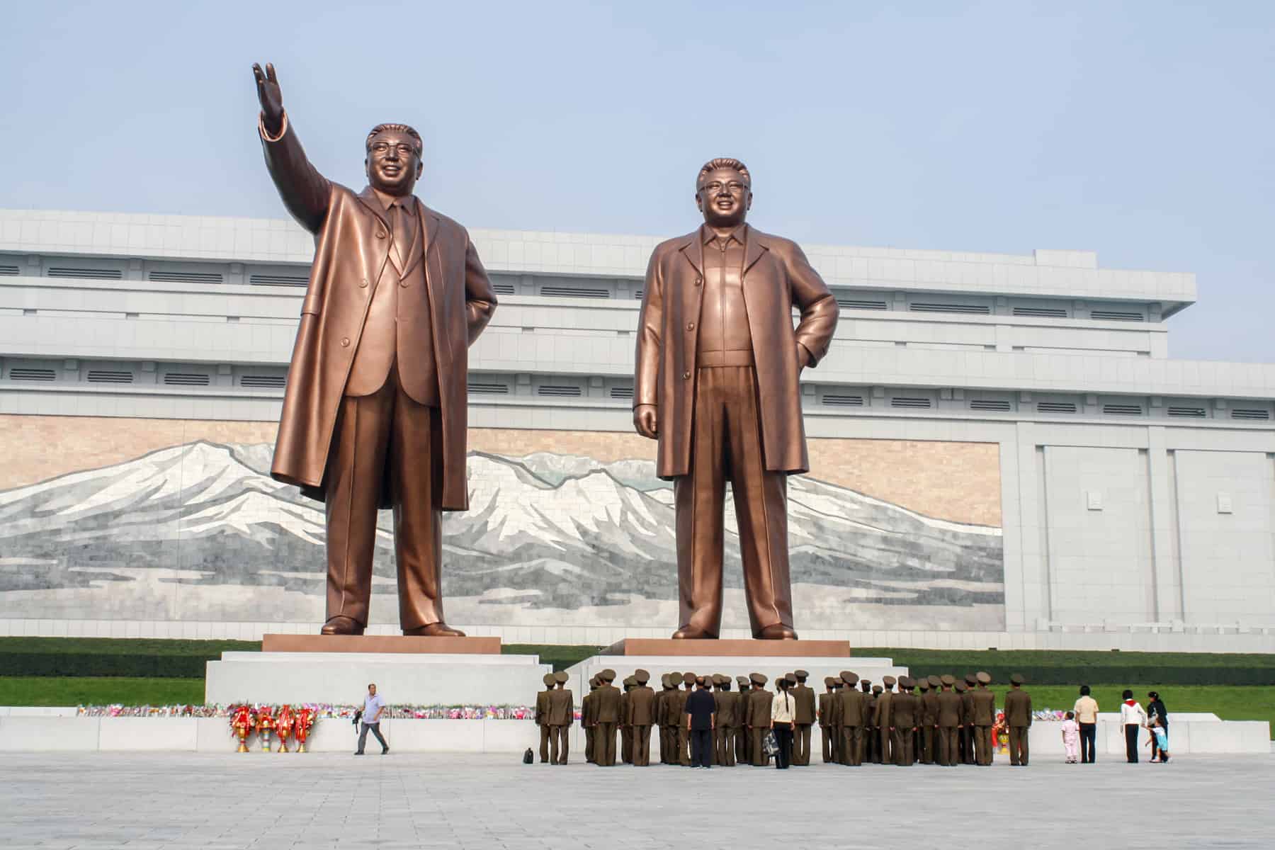 Two bronze statues of the Kims in North Korea.