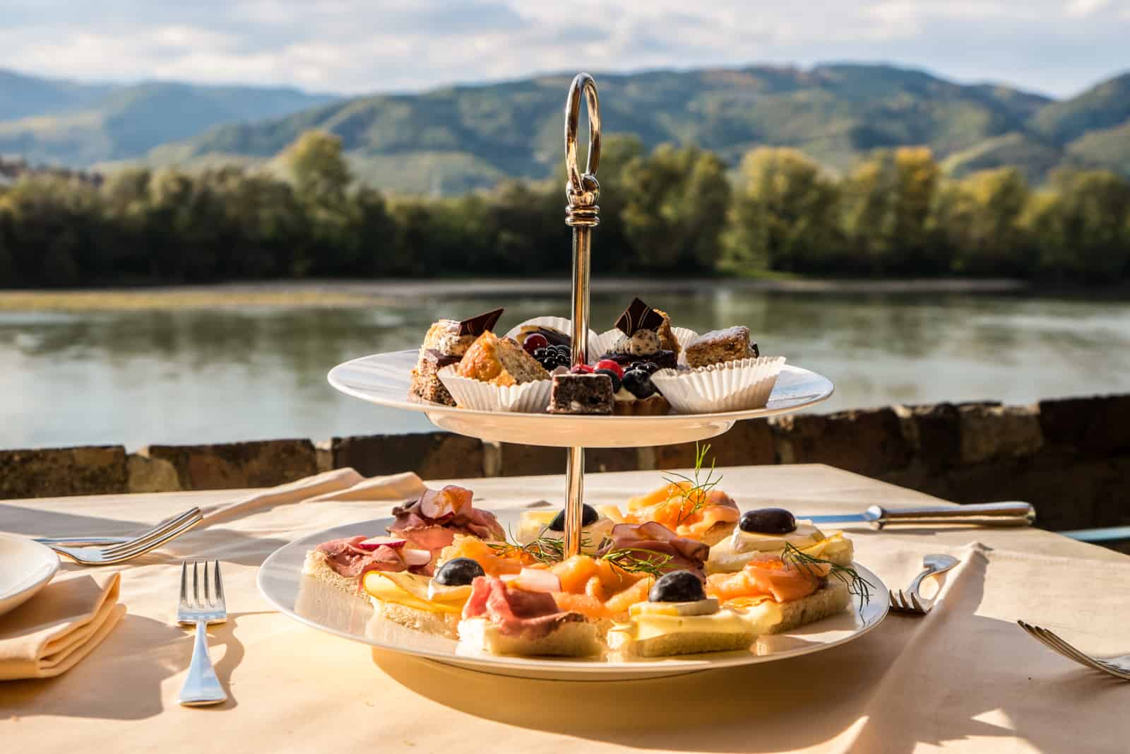 A two-tiered cake tray of afternoon tea at the Schlossberg Hotel in Durnstein overlooking the Danube River
