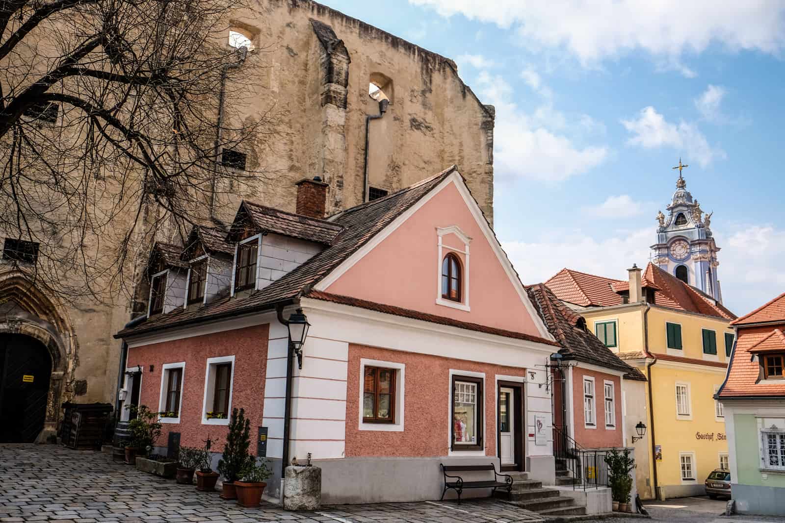 Pink, yellow and mint green buildings with red-roofs in Medieval Dürnstein, Austria