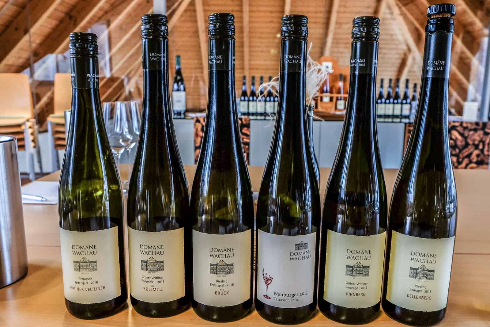A row of six bottles of wine at the Domäne Wachau wine during a wine tasting session