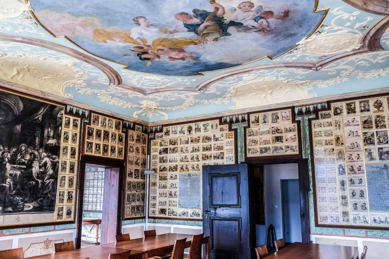 the painting mural ceiling and walls full of old black and white photographs inside the Domäne Wachau winery Cellar Palace