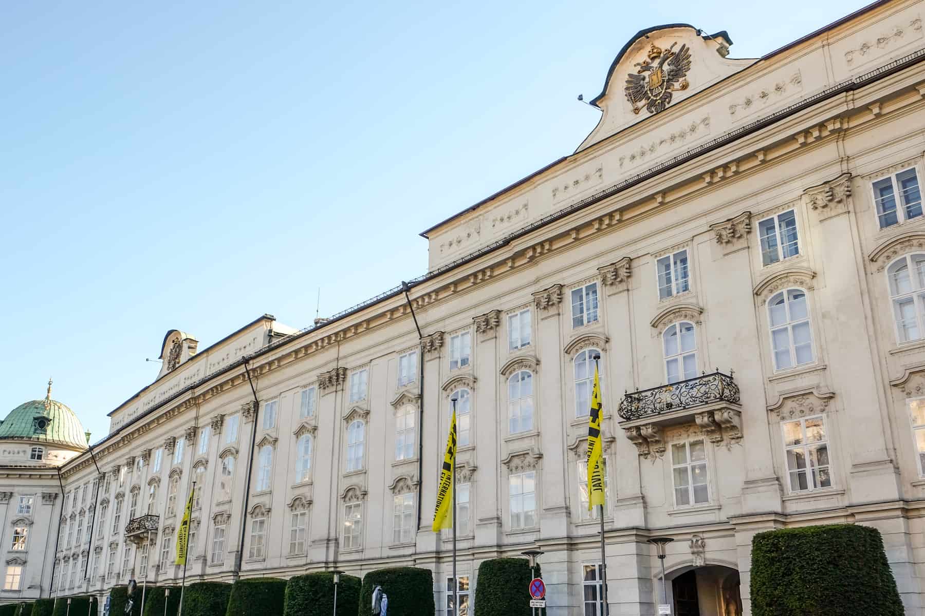 The long white, classical building facade of Hofburg Imperial Palace Innsbruck in Austria