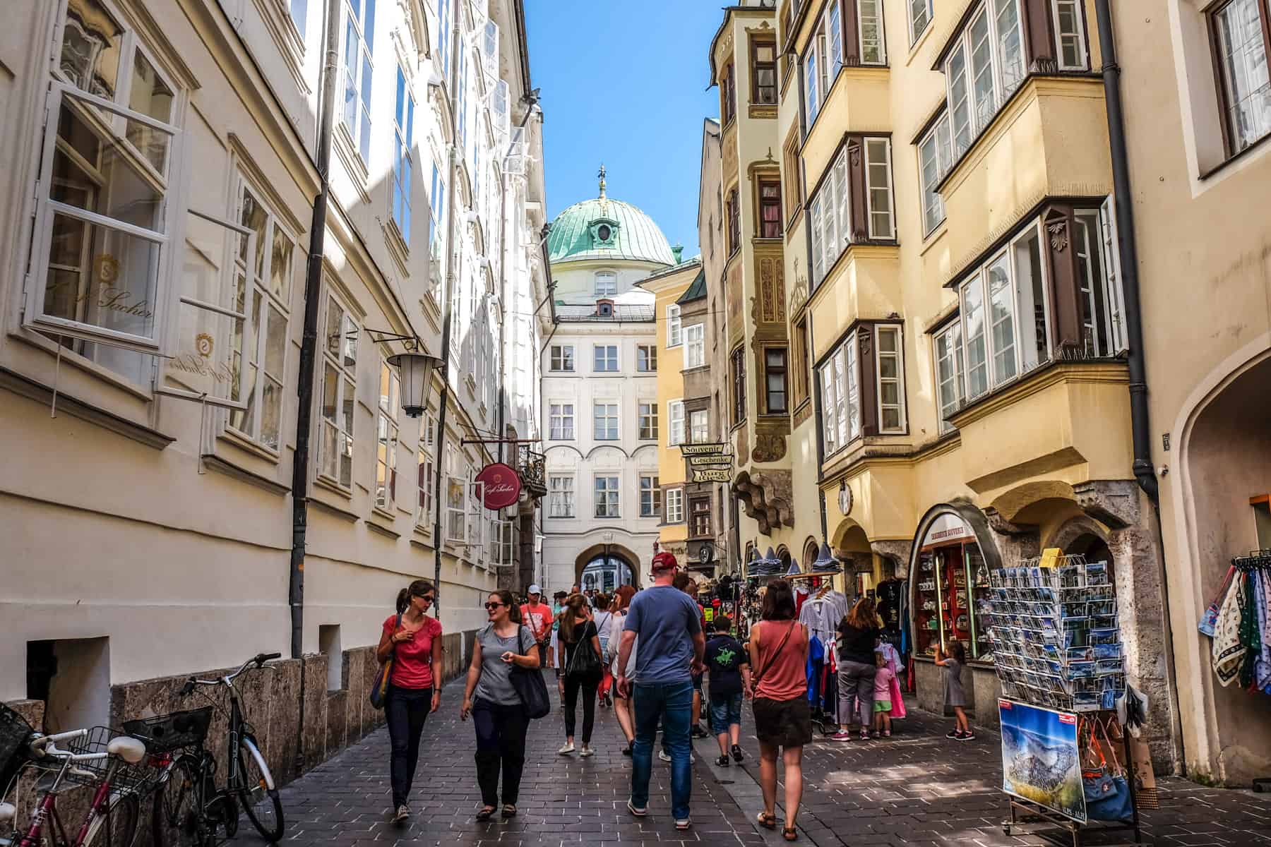 Streets of Innsbruck's Old Town looking towards the green dome roof of Hofburg Imperial Palace Innsbruck in Austria