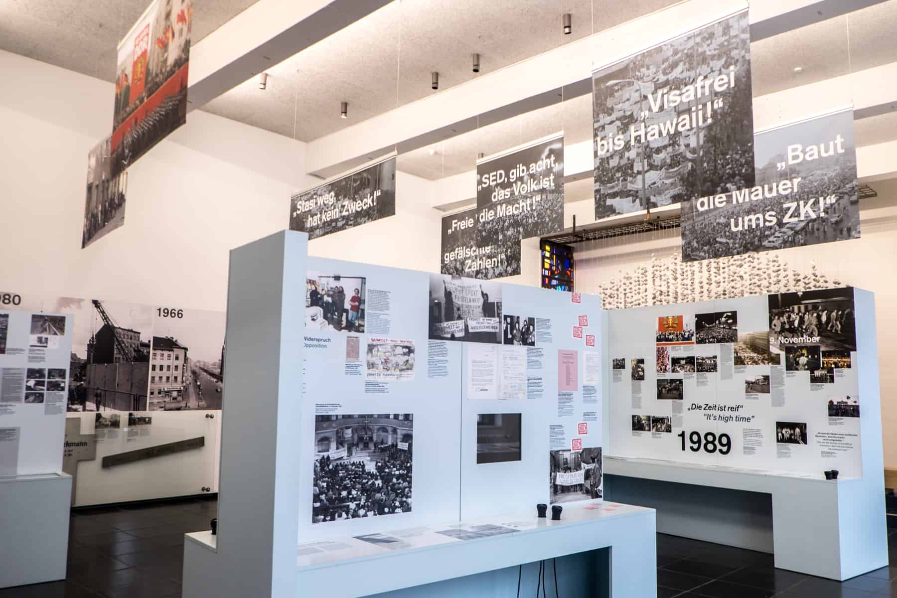 White information boards and hanging signs inside the Berlin Wall Documentation Centre