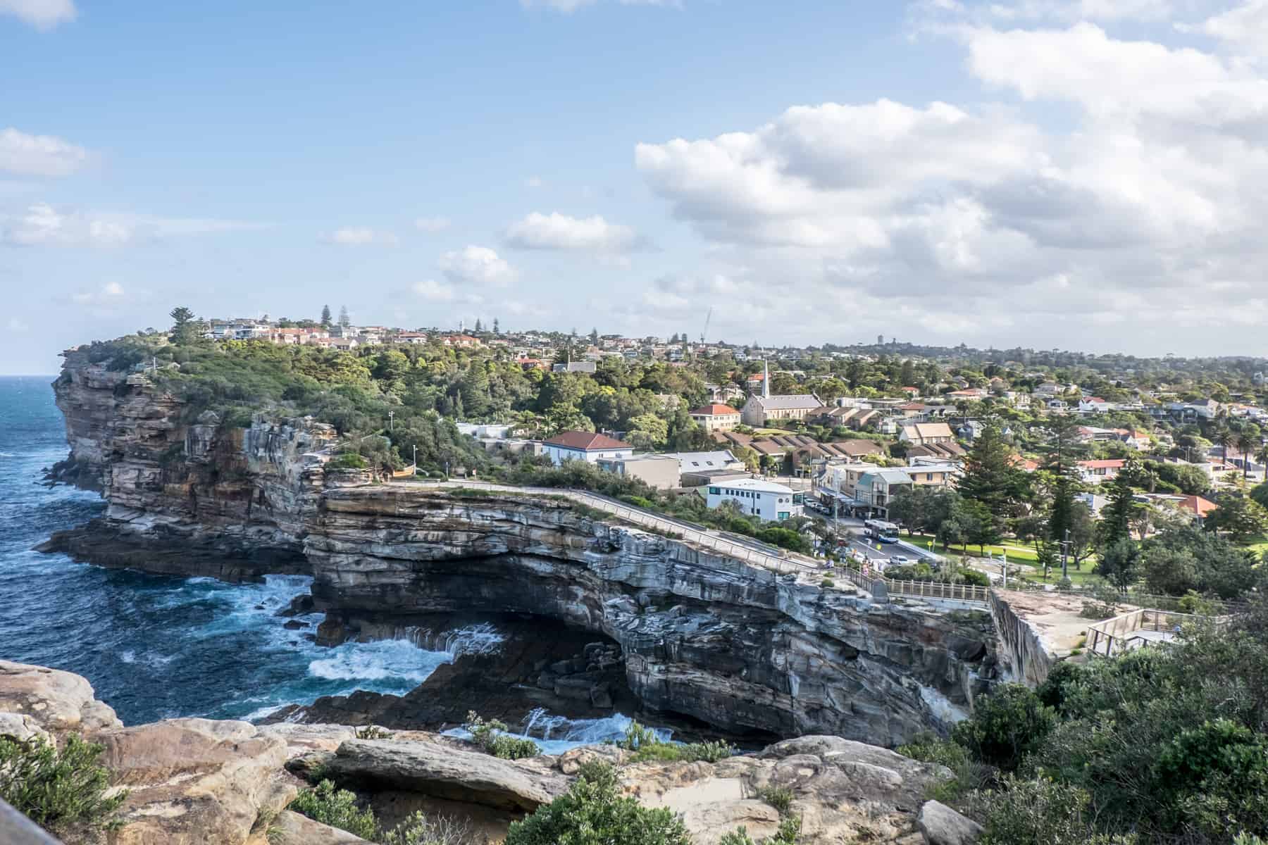 A view of a urban area of Sydney Australia with houses line a cliff top next to the ocean