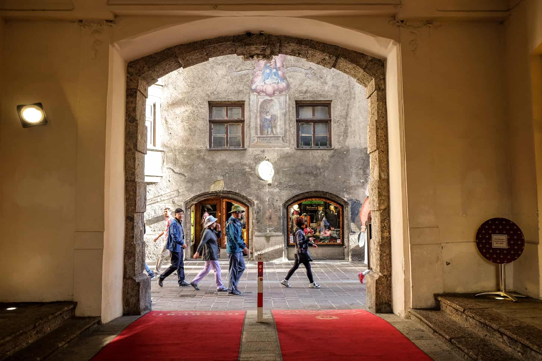 A grand doorway of the Palace in Innsbruck leads to the gothic style buildings on the streets