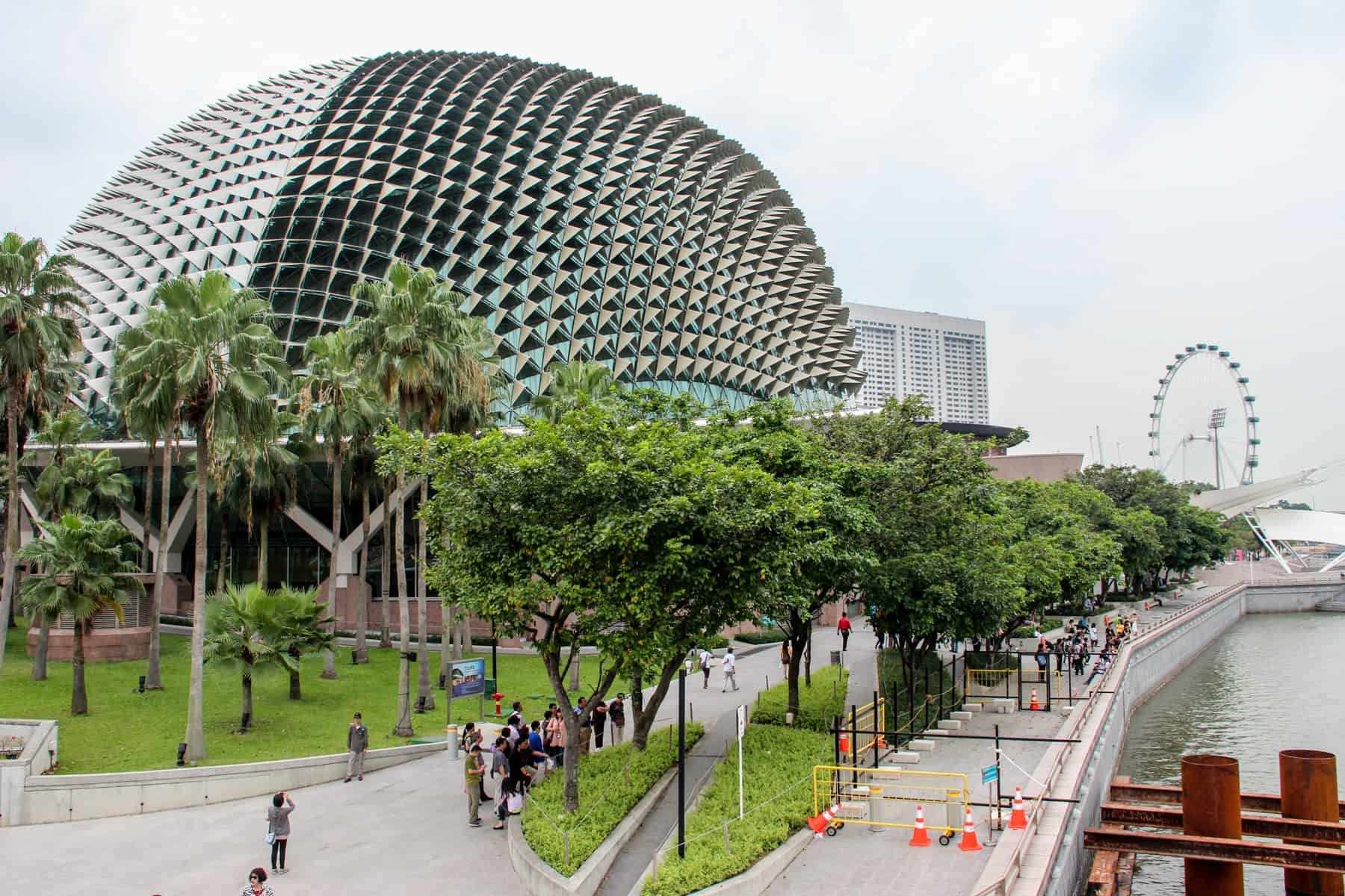The silver hedgehog building in Singapore is the Singapore Opera building that sit on the River surrounding by green trees and a long promenade walkway