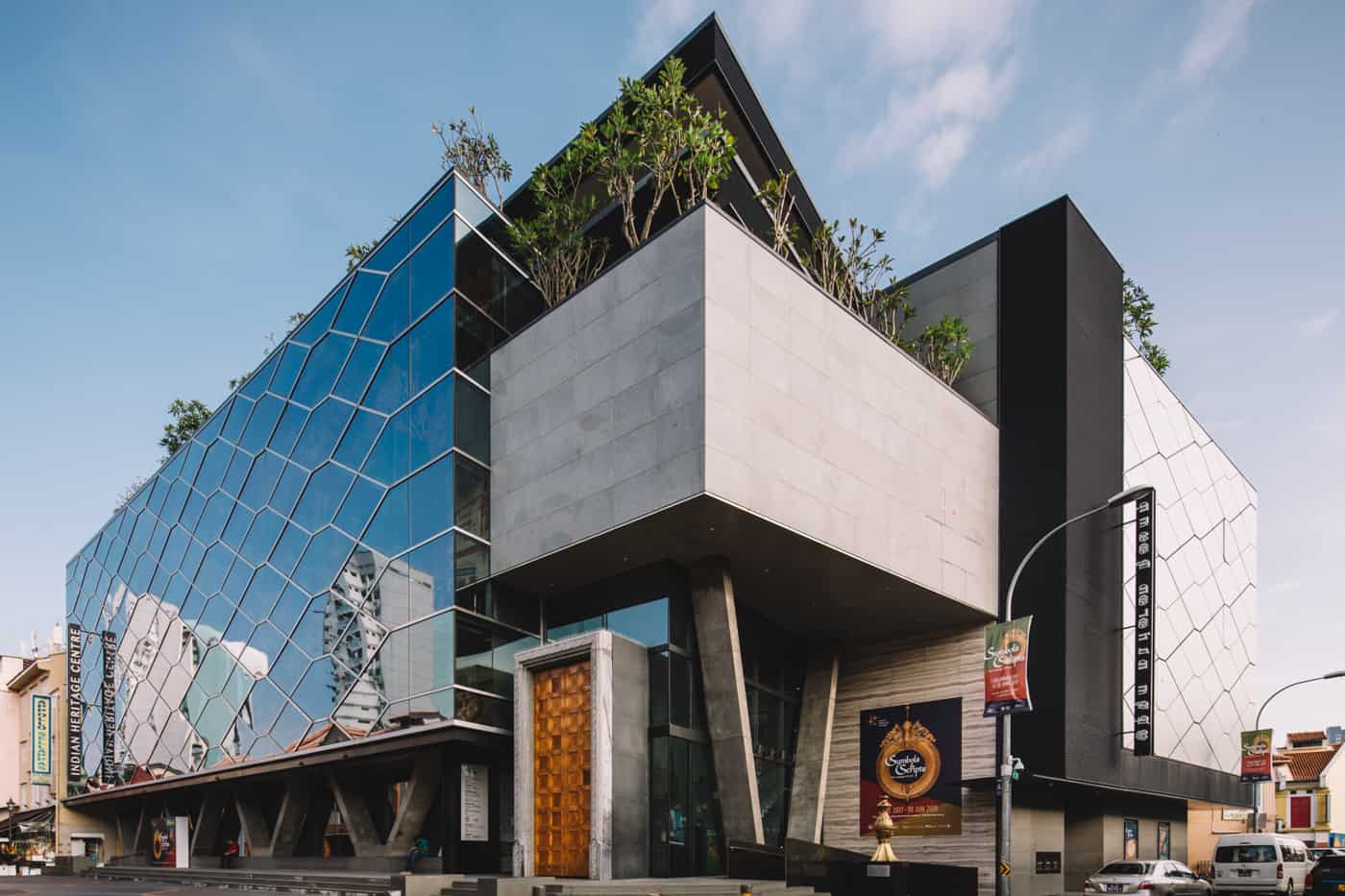 The glass facade and modern white block design of the Indian Heritage Centre in Singapore
