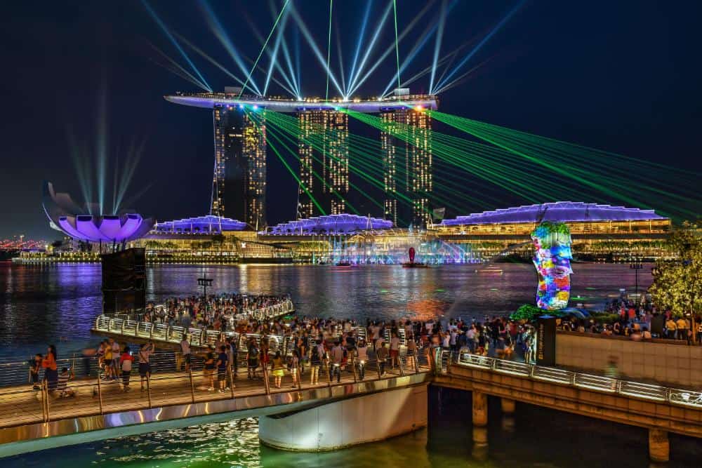 The purple, green and yellow light show at the Marina Bay in Singapore where the modern tree and boat shaped buildings put on a show at night