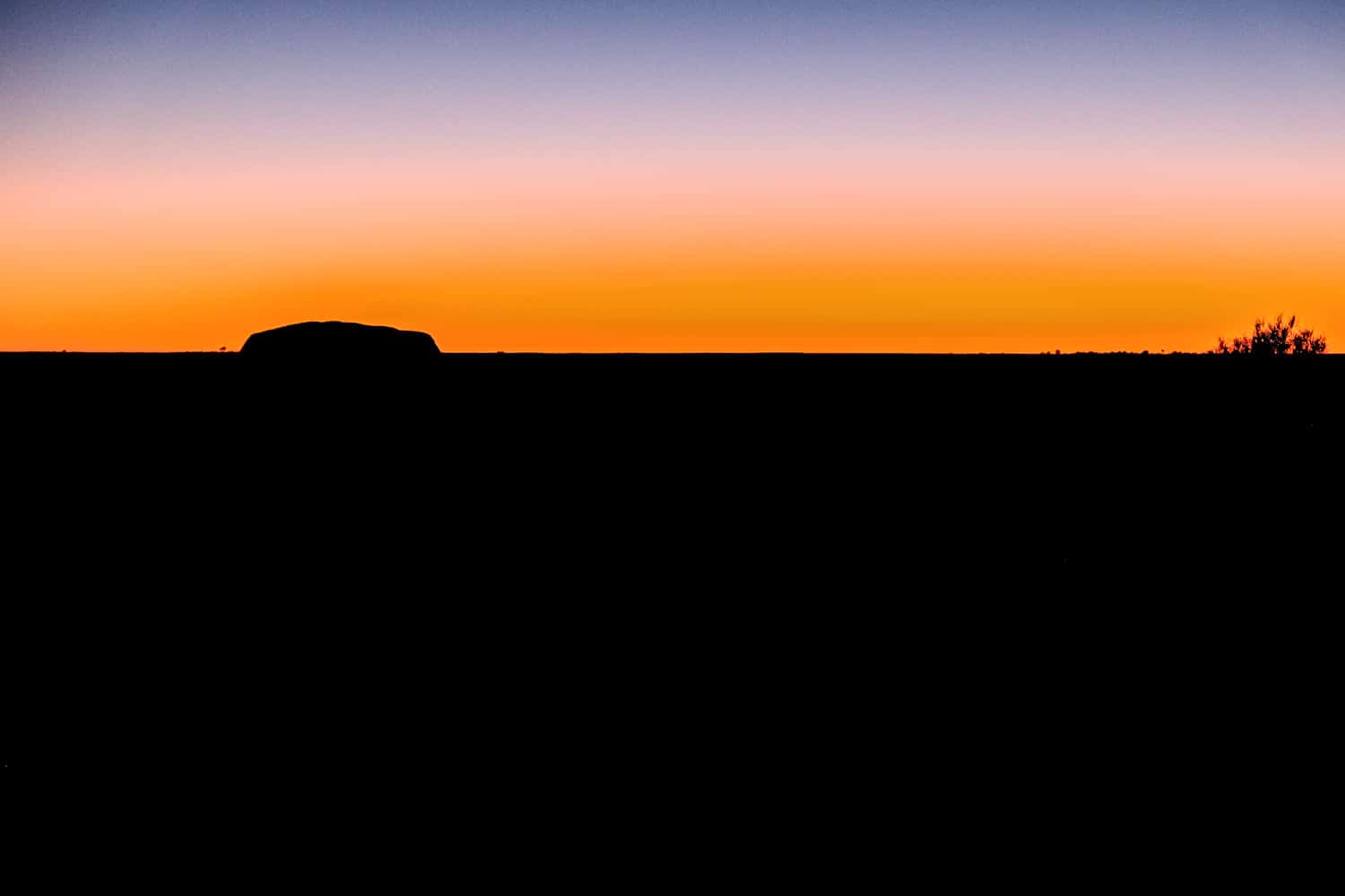Watching the sunrise above Uluru on a trip from Darwin to Alice Springs in the Northern Territory. 